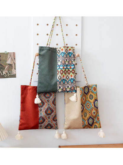 Cosbai Boho Ethnic Tassel Tote bag with ethnic design and tassels displayed on white surface