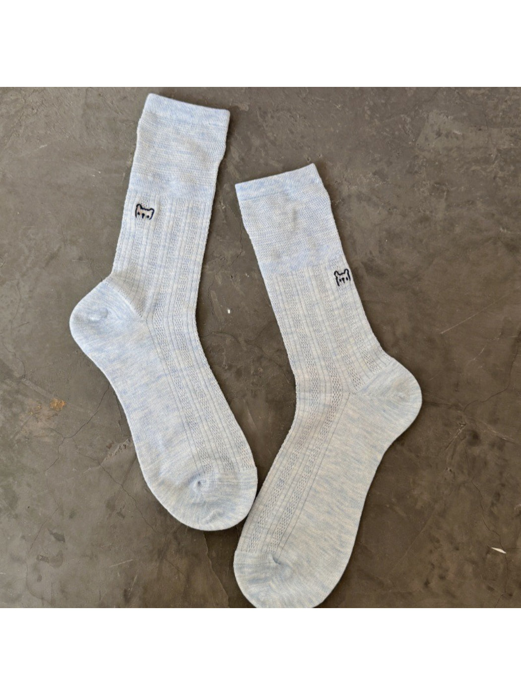 Model wearing Rufia white slouch socks with black cat embroidery