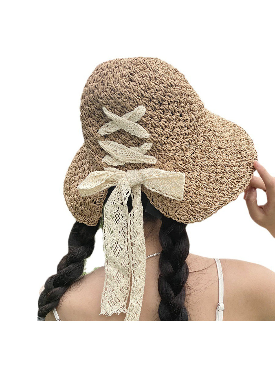 Model wearing Haila lace bow woven sun hat outdoors in sunlight