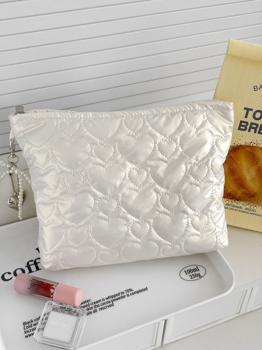 Cosbai cosmetic bag with heart pattern shown from a side angle