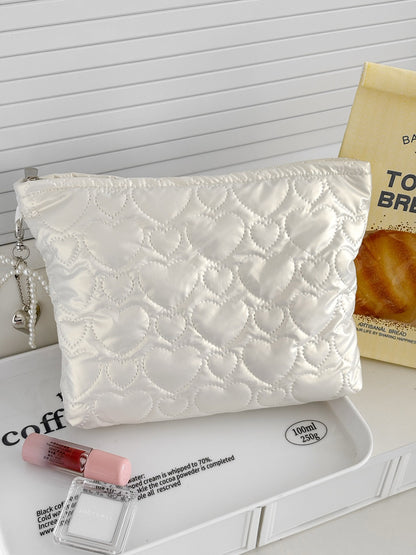 Cosbai cosmetic bag with heart pattern shown from a side angle