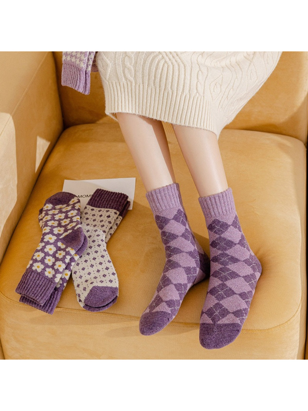 Rufia purple crew socks styled on couch