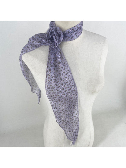 Side view of model wearing scarf tied in a bow at the neck