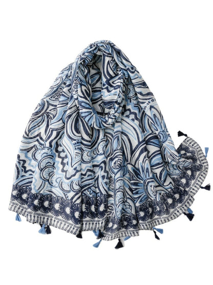 Blue boho scarf with tassels draped on a wooden hanger