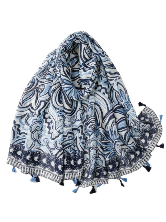 Blue boho scarf with tassels draped on a wooden hanger