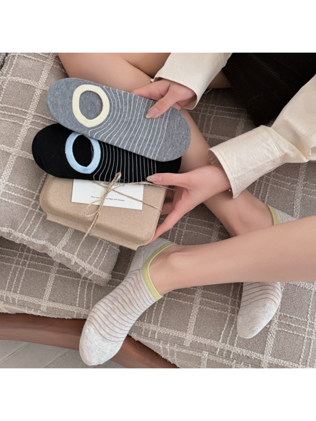 Rufia striped low cut liner socks in white with black and gray stripes, flat lay on white background