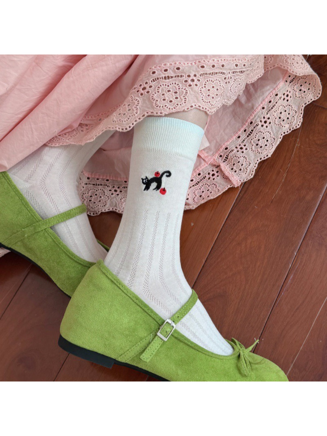 Close-up of black cat design on Rufia black cat crew socks