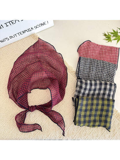 Classic check pattern tie head scarf folded on a white background