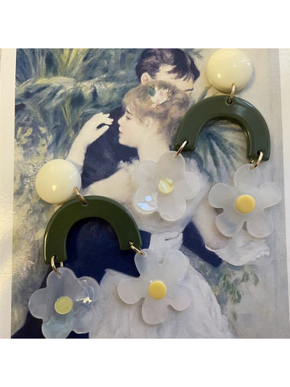 Pair of green arch daisy earrings displayed on a white background