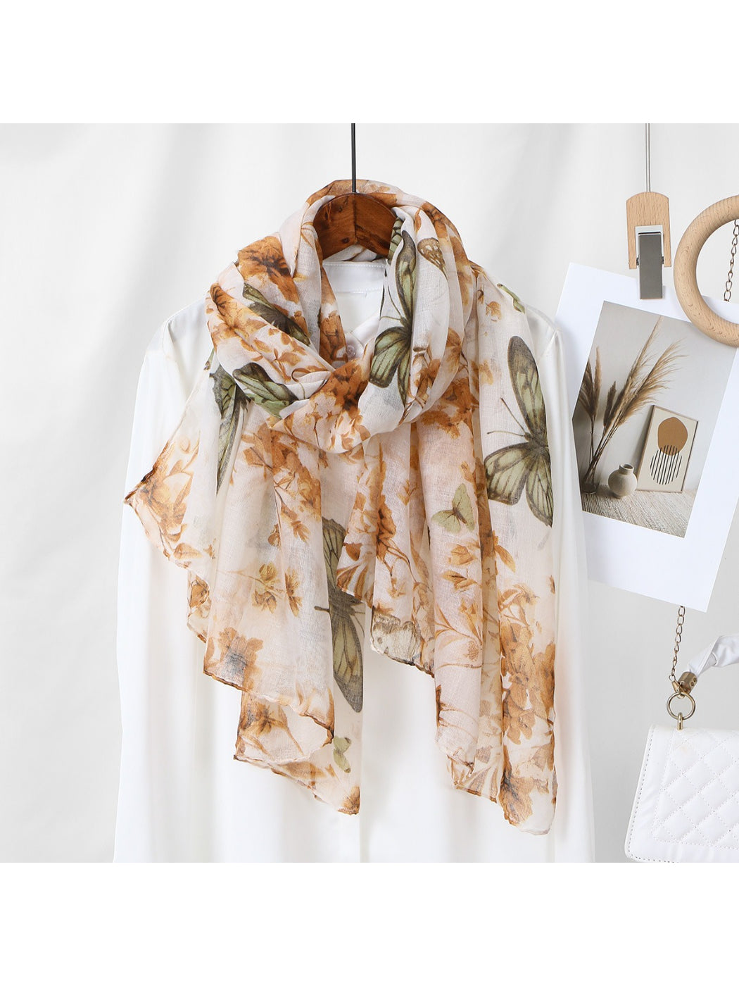 Scarvii scarf styled as a head wrap featuring butterfly and botanical patterns