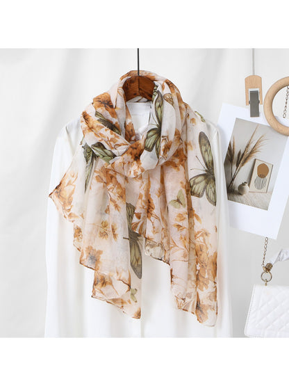 Scarvii scarf styled as a head wrap featuring butterfly and botanical patterns