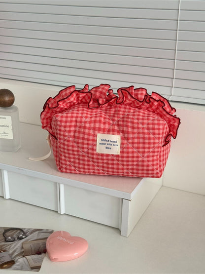 Side view of Cosbai ruffle trim gingham makeup bag highlighting shape and texture