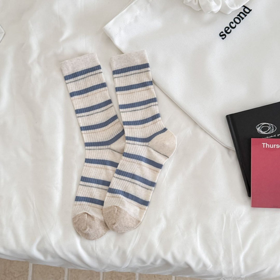 Rufia ribbed socks worn on feet showing fit and striped pattern