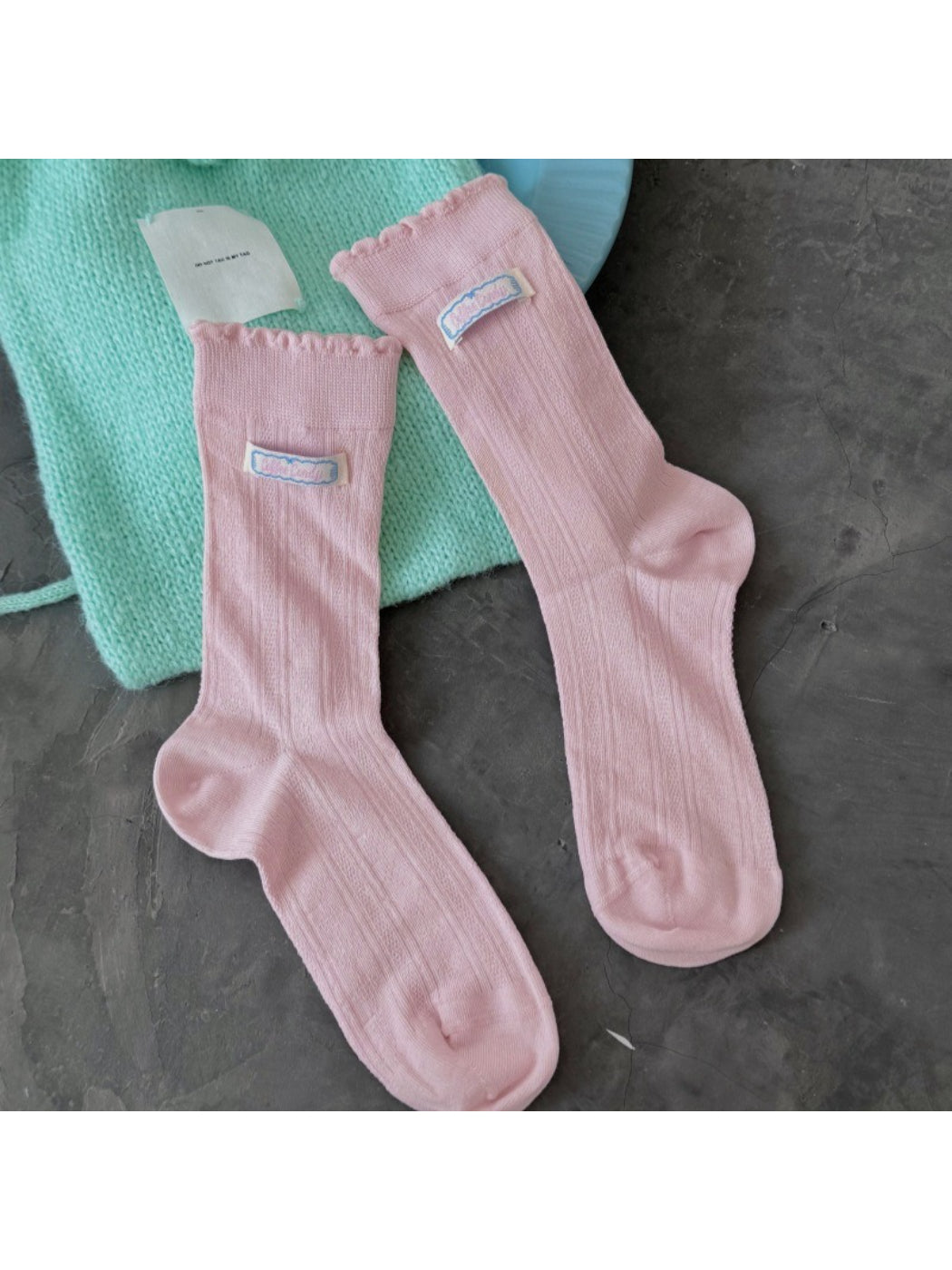 Rufia socks folded neatly with scalloped trim visible on top