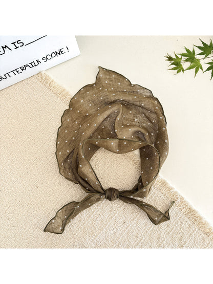 Scarvii head scarf with black polka dots on white fabric displayed on mannequin