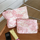 Cosbai pink floral cosmetic bag with vibrant flower pattern on a light background