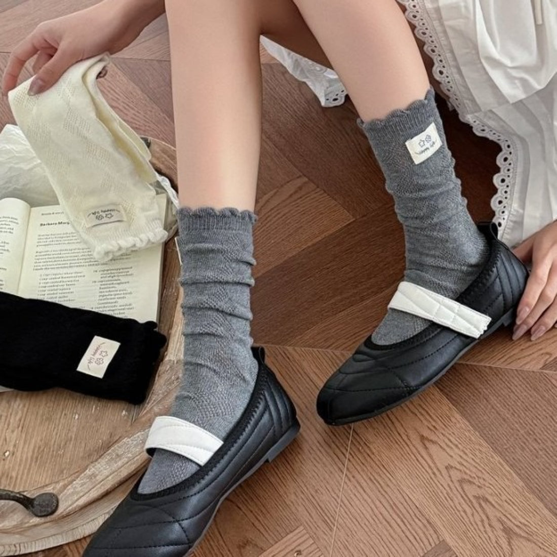 Pair of Rufia Fine Stripe Charm Crew Socks in beige with thin stripes on a white background