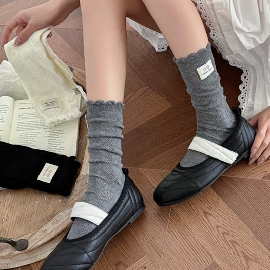 Pair of Rufia Fine Stripe Charm Crew Socks in beige with thin stripes on a white background