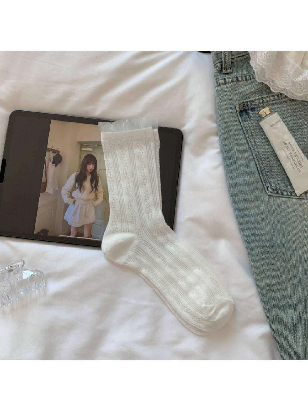 Model wearing Rufia sheer wave pattern crew socks with white sneakers