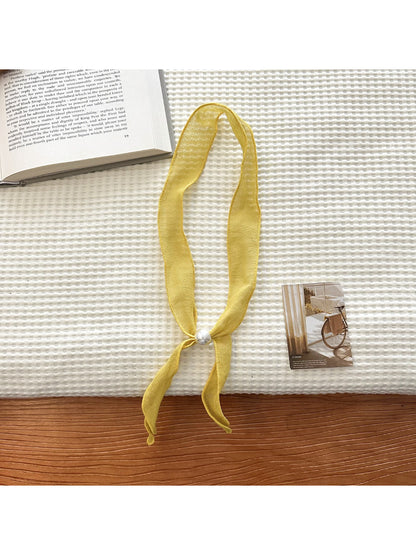 Detailed view of bead accents on sheer skinny scarf fabric