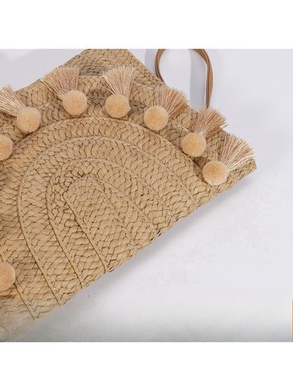 Side view of Cosbai woven tassel clutch bag showing thickness and tassels