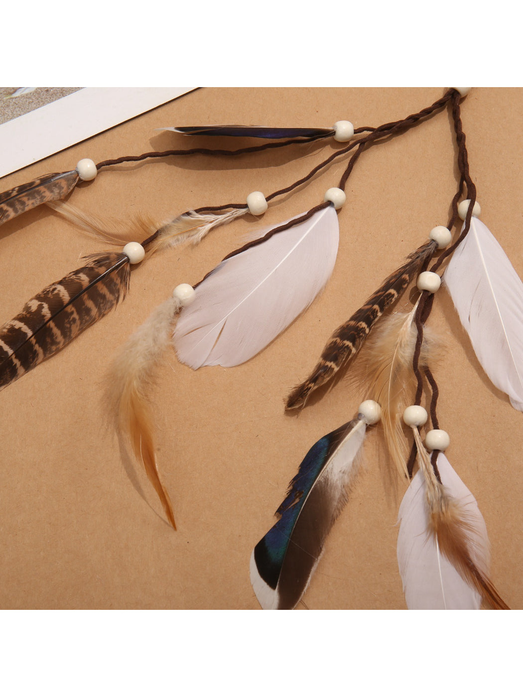 Boho shell feather tassel hair headpiece displayed flat with shells and feather tassels visible