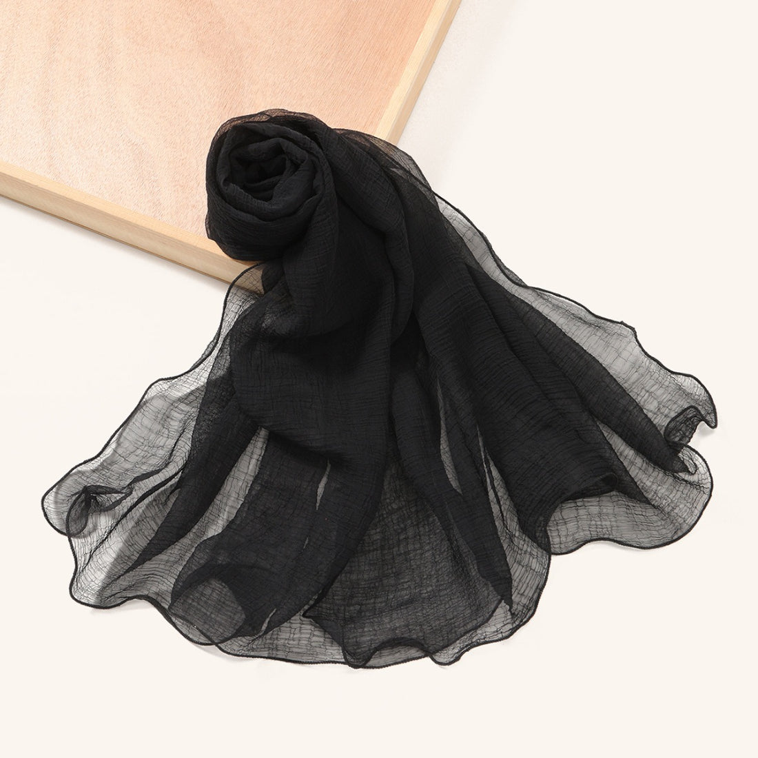 Model wearing Scarvii wavy edge textured shawl scarf draped over shoulders
