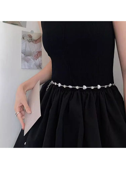 Model wearing Beco delicate heart chain waist belt over a dress