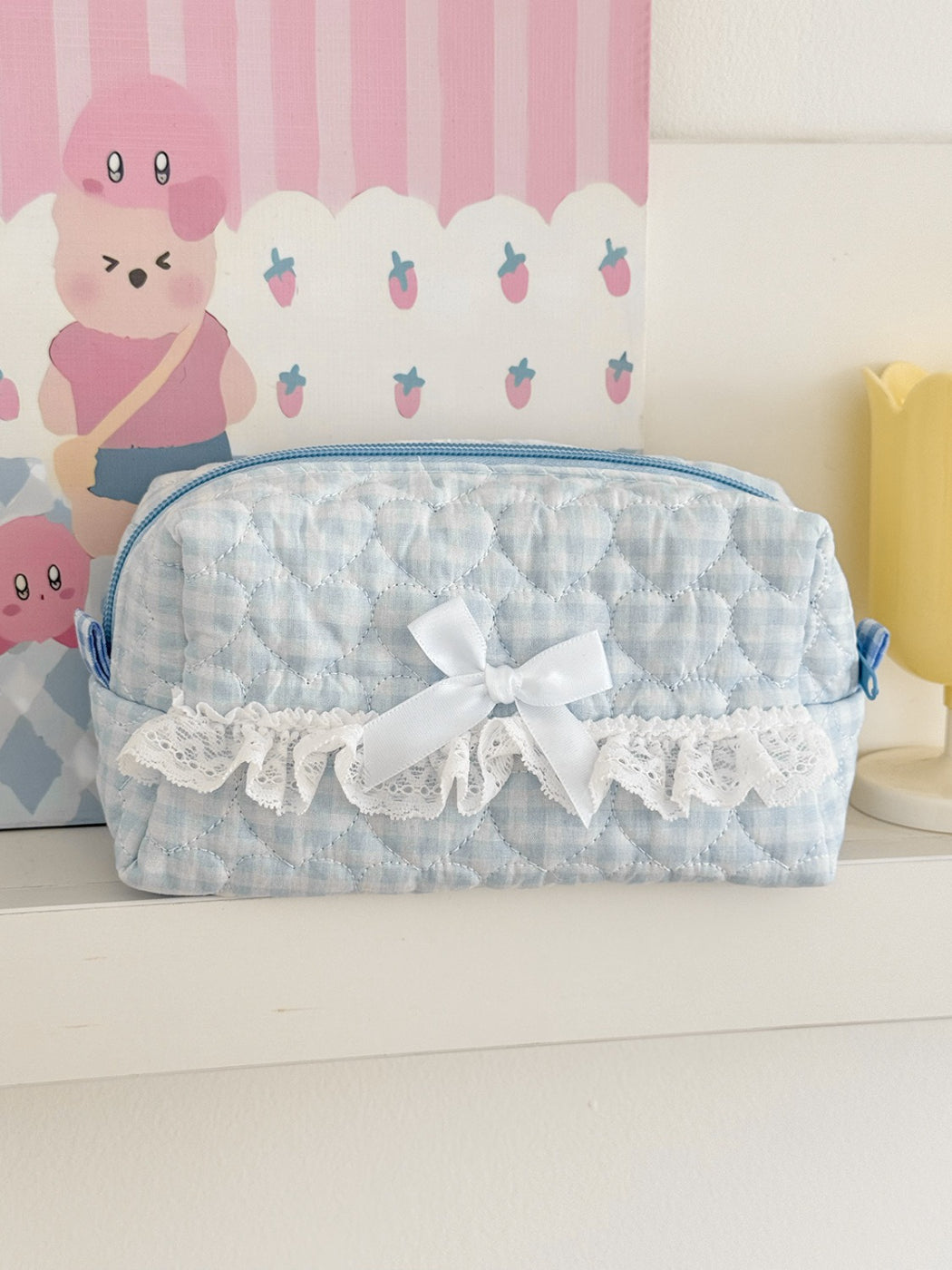 Side view of Cosbai lace bow gingham cosmetic pouch highlighting fabric texture