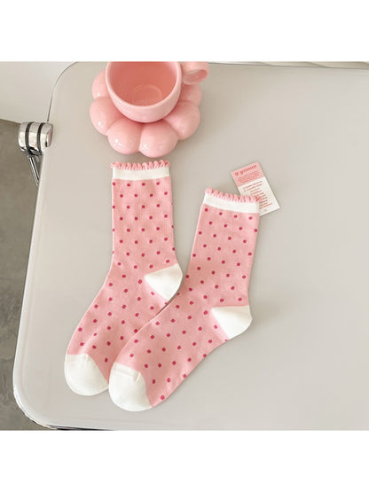 Rufia pink floral ribbed crew socks folded neatly on a white surface