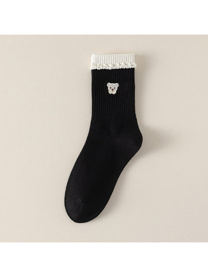 Pair of Rufia beige ribbed socks with teddy detail standing upright