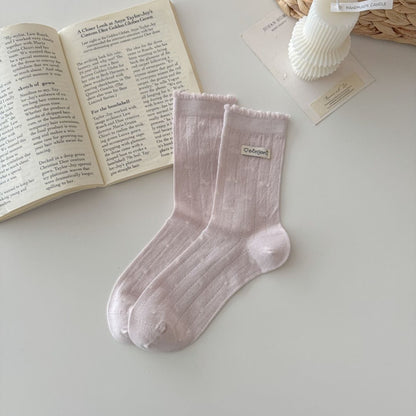 Side view of Rufia soft knit crew socks showing ruffle trim and texture