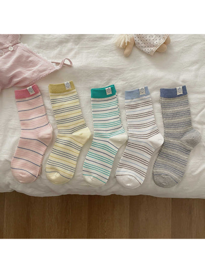Close-up of Rufia socks showing soft striped pattern and patch detail