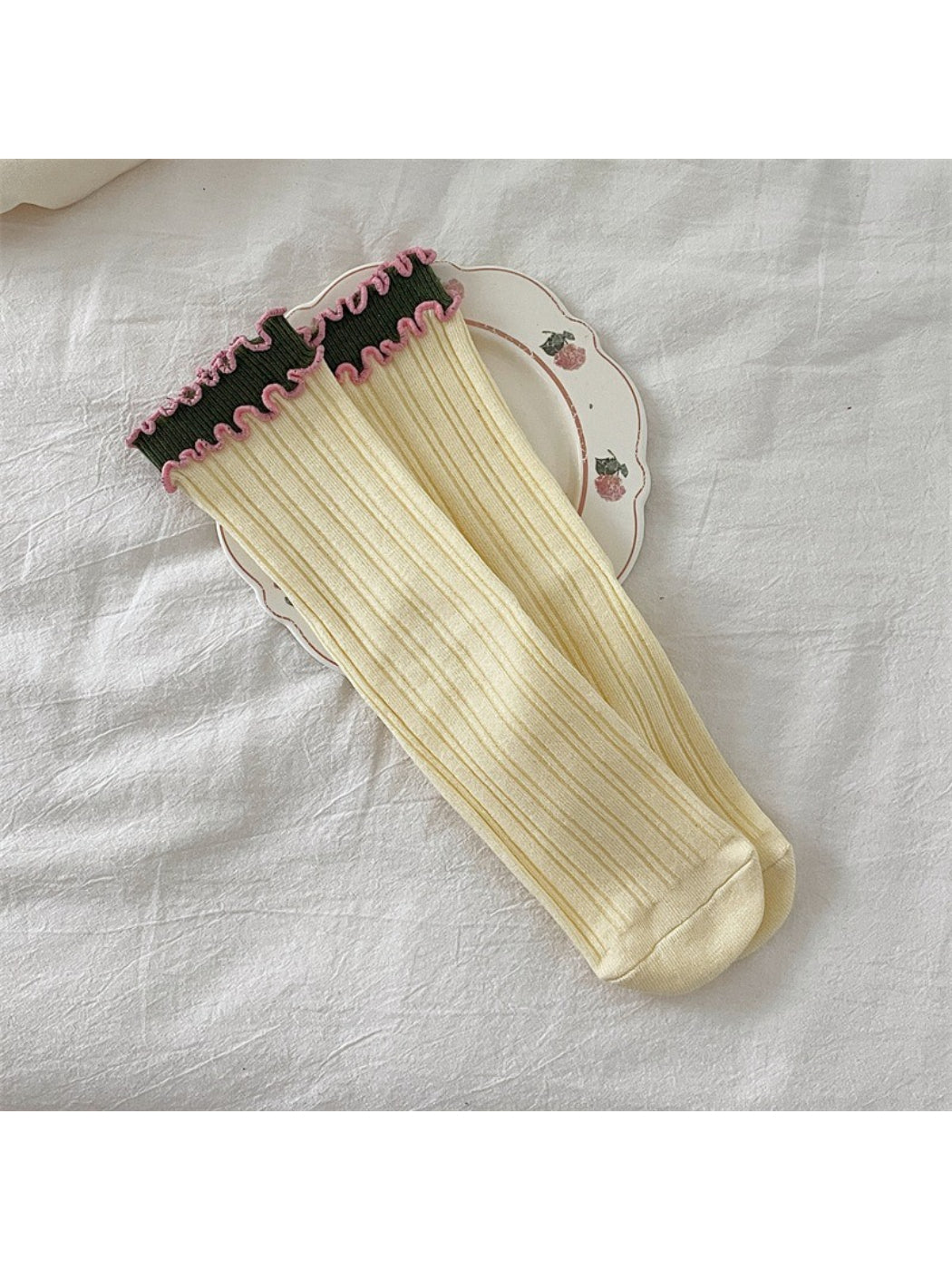 Side view of Rufia ruffle color block crew socks showing ruffle trim and color sections