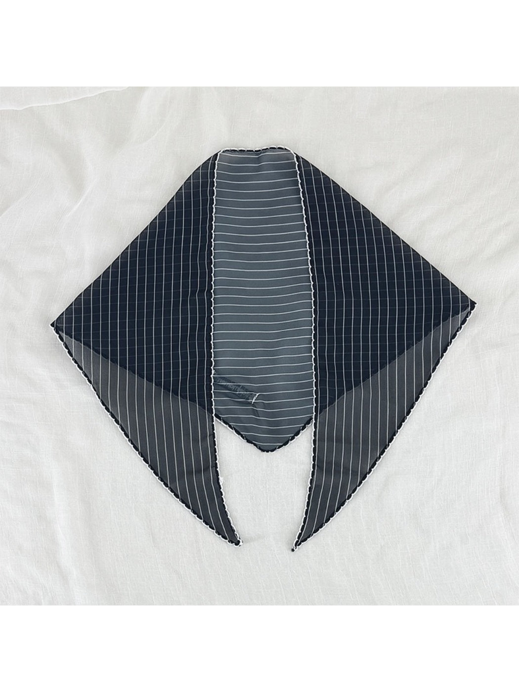 Scarvii pleated triangle scarf displayed on white background showing shape and trim
