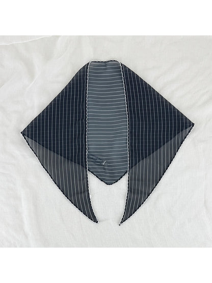 Scarvii pleated triangle scarf displayed on white background showing shape and trim