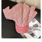 Haila Floral Bonnet Cap with vibrant flowers on fabric, styled for wear