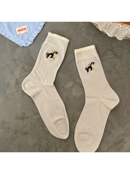 Rufia black cat crew socks displayed rolled up showing cat face