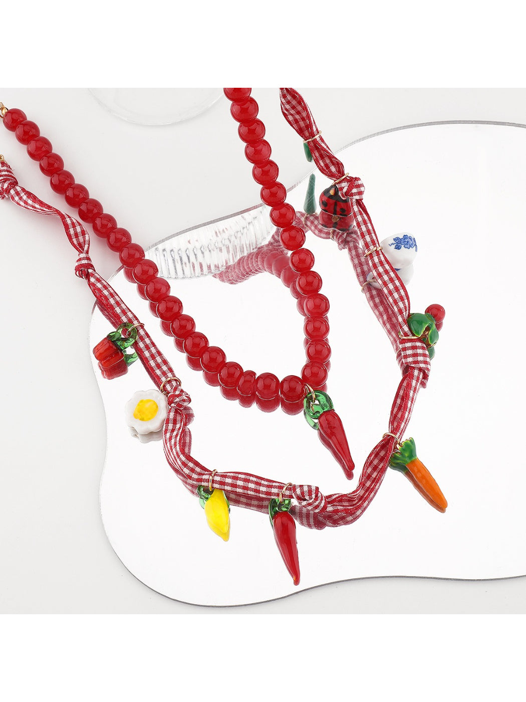 Side view of the silver chain and clasp of the Neckit Playful Food Charm Necklace