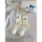 Rufia Classic Fine Texture Crew Socks folded neatly on wooden surface
