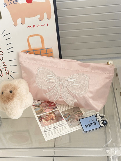 Side view of the Cosbai elegant bow cosmetic pouch highlighting its slim profile