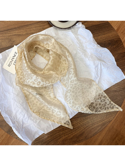 Sheer leopard print scarf folded neatly highlighting fabric texture
