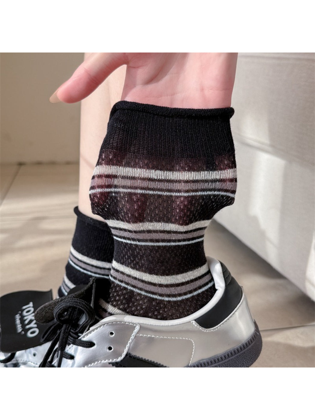 Model wearing Rufia rolled edge stripe socks with rolled cuff and navy stripes