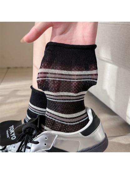 Model wearing Rufia rolled edge stripe socks with rolled cuff and navy stripes