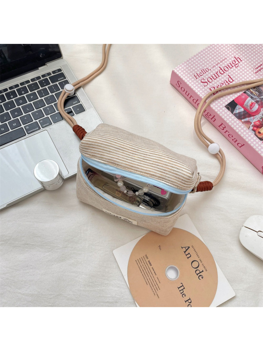 Cosbai striped mini crossbody pouch displayed on a flat surface with the strap extended