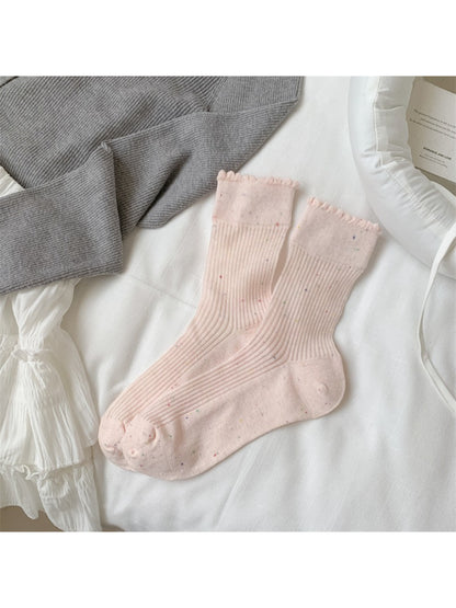 Rufia rib crew socks worn with rolled-up pants to showcase speckled knit texture