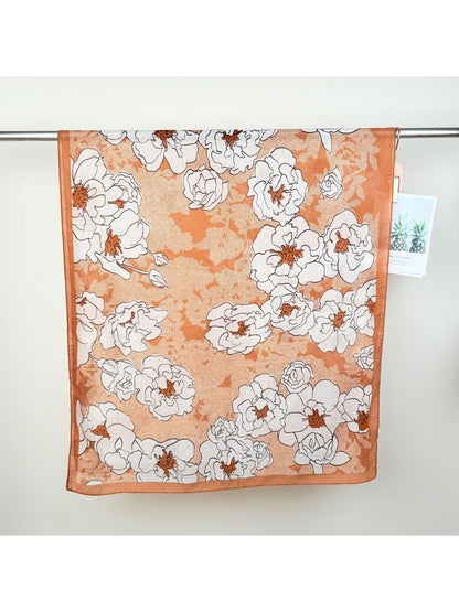 Model styling Scarvii Statement Flower Wrap Scarf as a head wrap with bold flower print