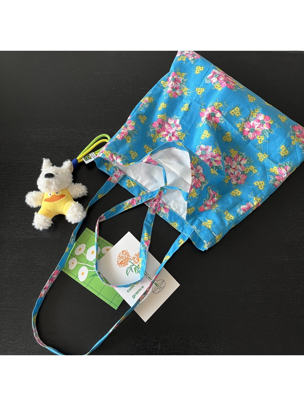 Close-up of floral pattern and black shoulder straps on Cosbai Painterly Bloom Tote