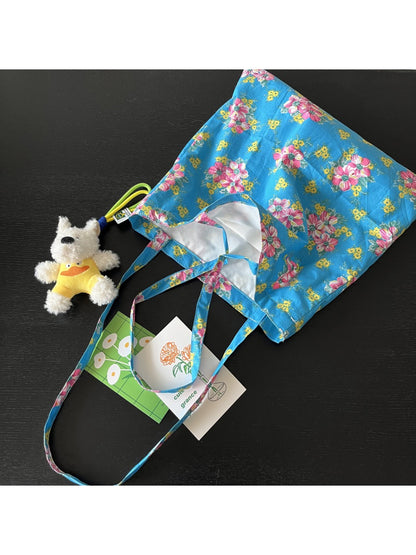 Close-up of floral pattern and black shoulder straps on Cosbai Painterly Bloom Tote