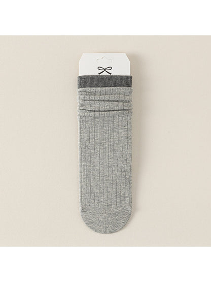 Close-up of black Rufia ribbed mid-calf sock showing ribbed texture and toe seam